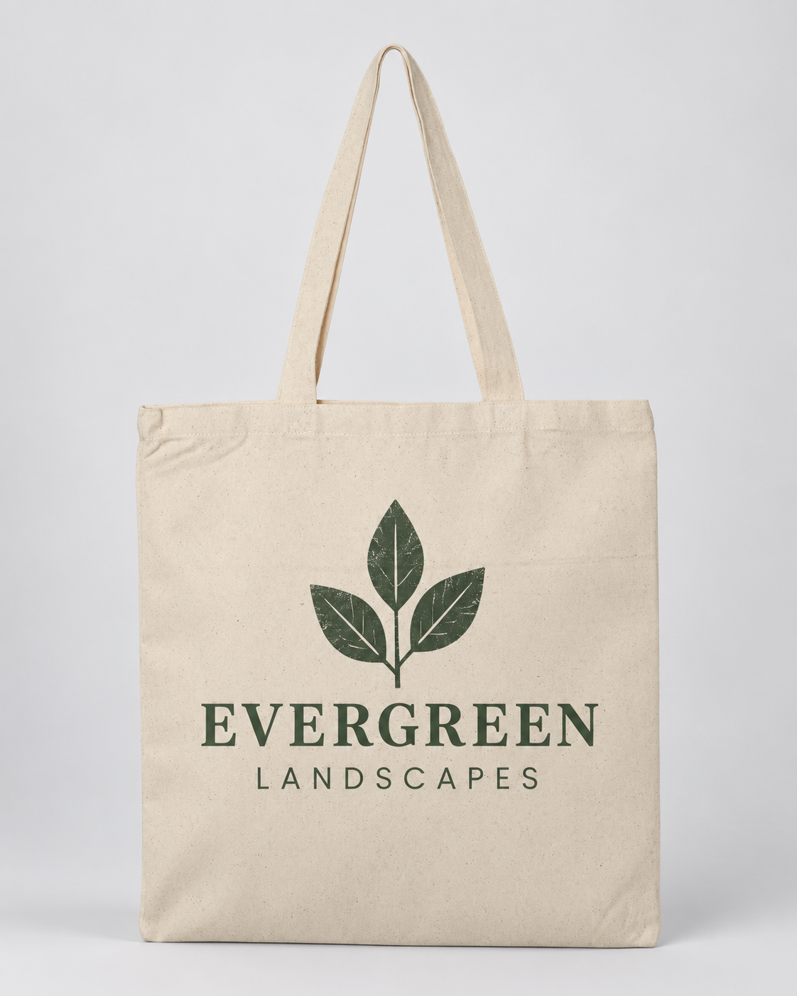 Illustrative business mockup. Natural canvas tote printed with Evergreen Landscapes logo