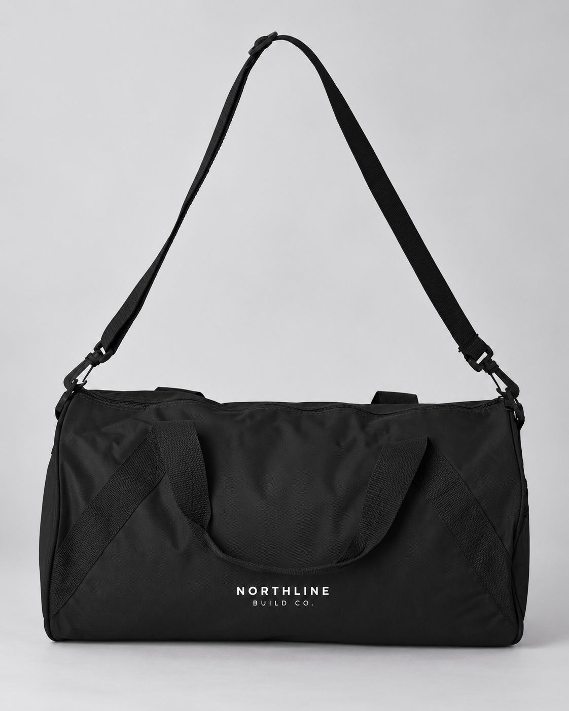 Illustrative business mockup. Black duffel bag printed with white Northline Build Co. logo
