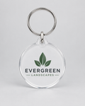 Illustrative business mockup. Clear acrylic keychain with Evergreen Landscapes logo