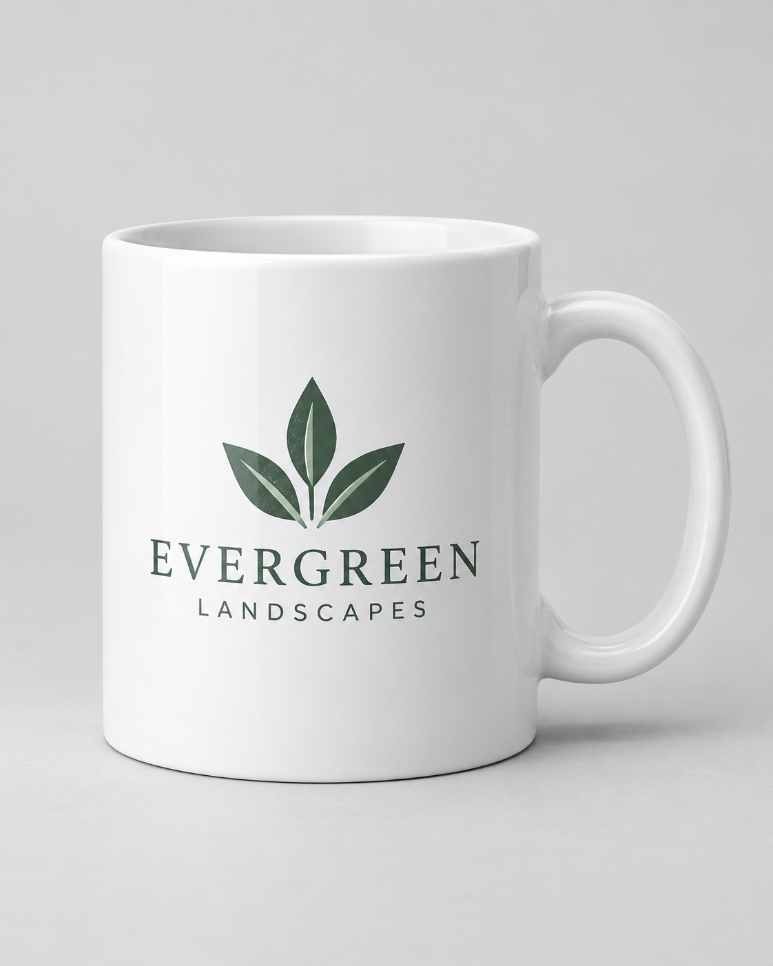 Illustrative business mockup. White ceramic mug printed with Evergreen Landscapes branding