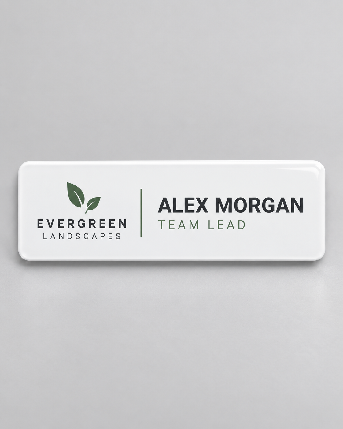 Illustrative business mockup. White Evergreen Landscapes staff badge for Alex Morgan