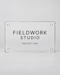 Illustrative business mockup. Clear acrylic Fieldwork Studio reception sign