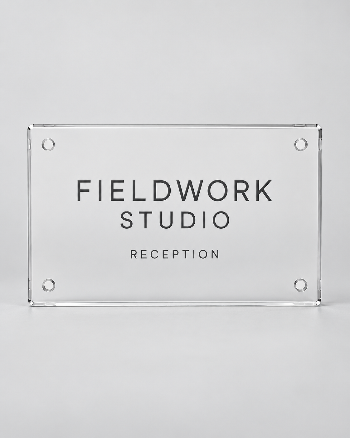 Illustrative business mockup. Clear acrylic Fieldwork Studio reception sign