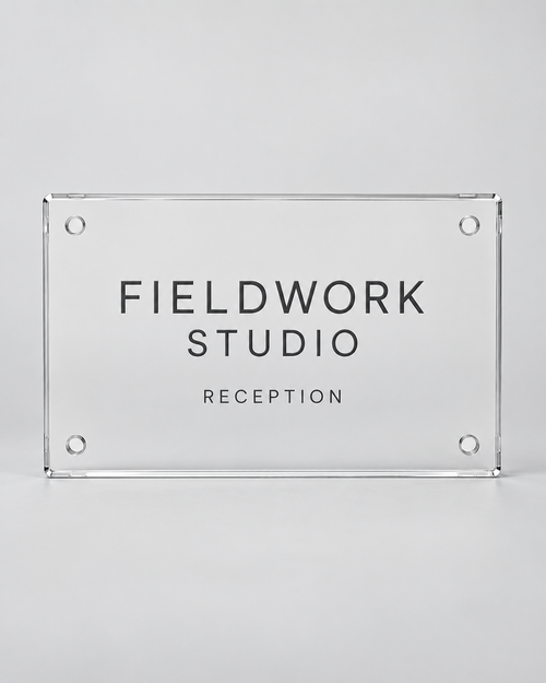 Illustrative business mockup. Clear acrylic Fieldwork Studio reception sign