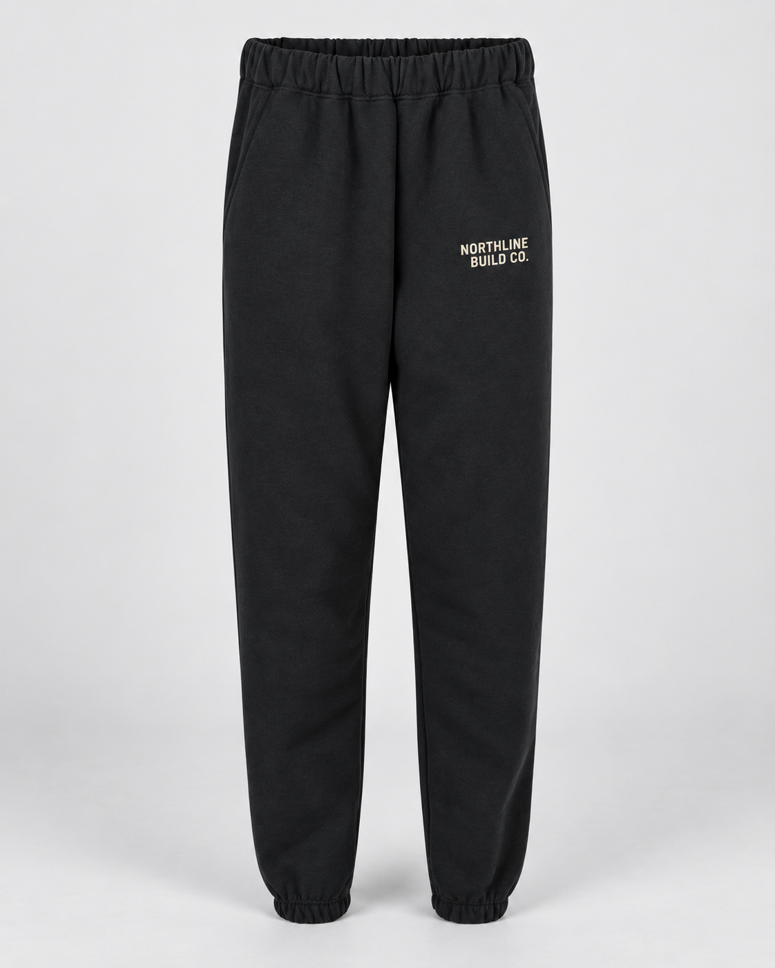 Illustrative business mockup. Gildan SF100 Softstyle pocket sweatpants with a small professional business logo on a neutral studio background