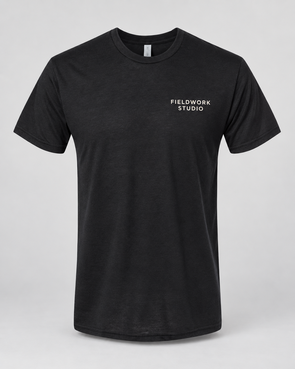 Illustrative business mockup. Next Level 6010 Soft triblend T-shirt with a small professional business logo on a neutral studio background