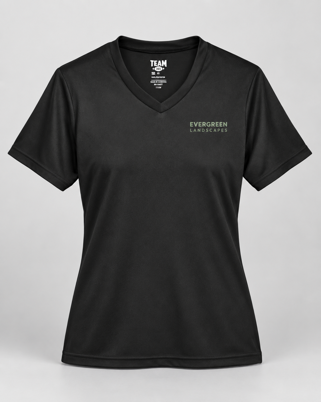 Illustrative business mockup. Team 365 TT11W Women’s performance V-neck with a small professional business logo on a neutral studio background