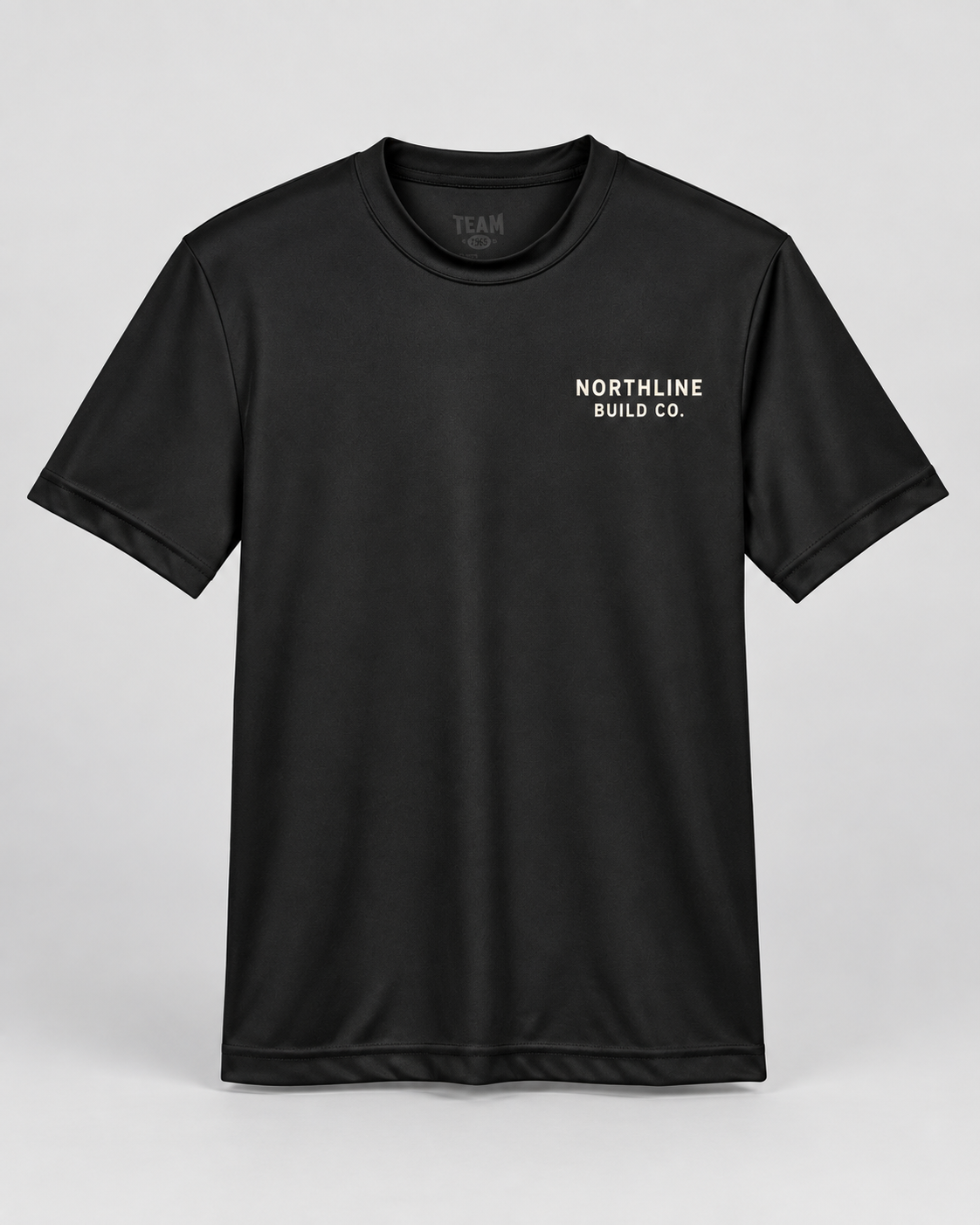 Illustrative business mockup. Team 365 TT11Y Youth performance T-shirt with a small professional business logo on a neutral studio background