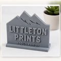 Simple 3D printed desk display with sample Littleton artwork on a bright studio background sample image