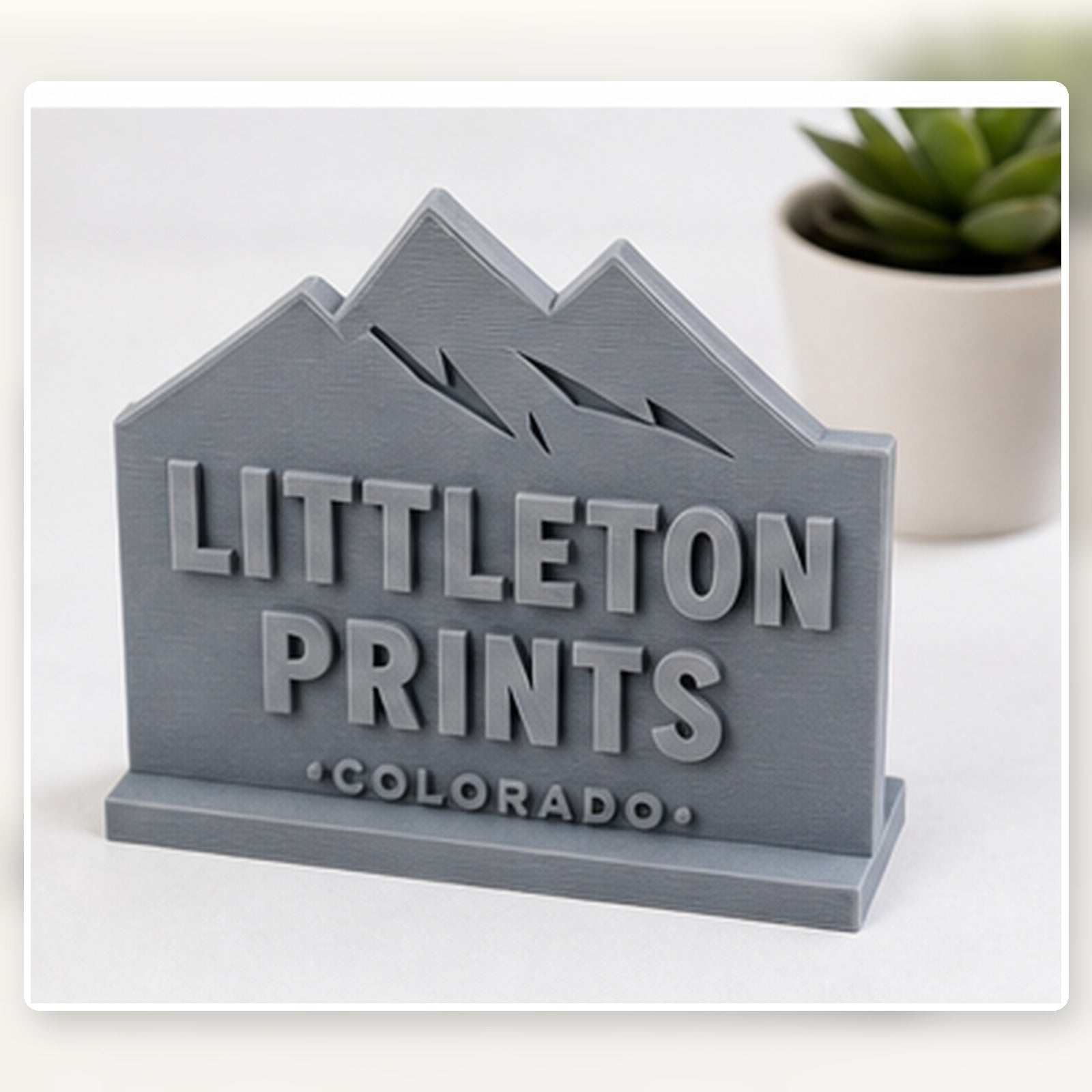 Simple 3D printed desk display with sample Littleton artwork on a bright studio background sample image